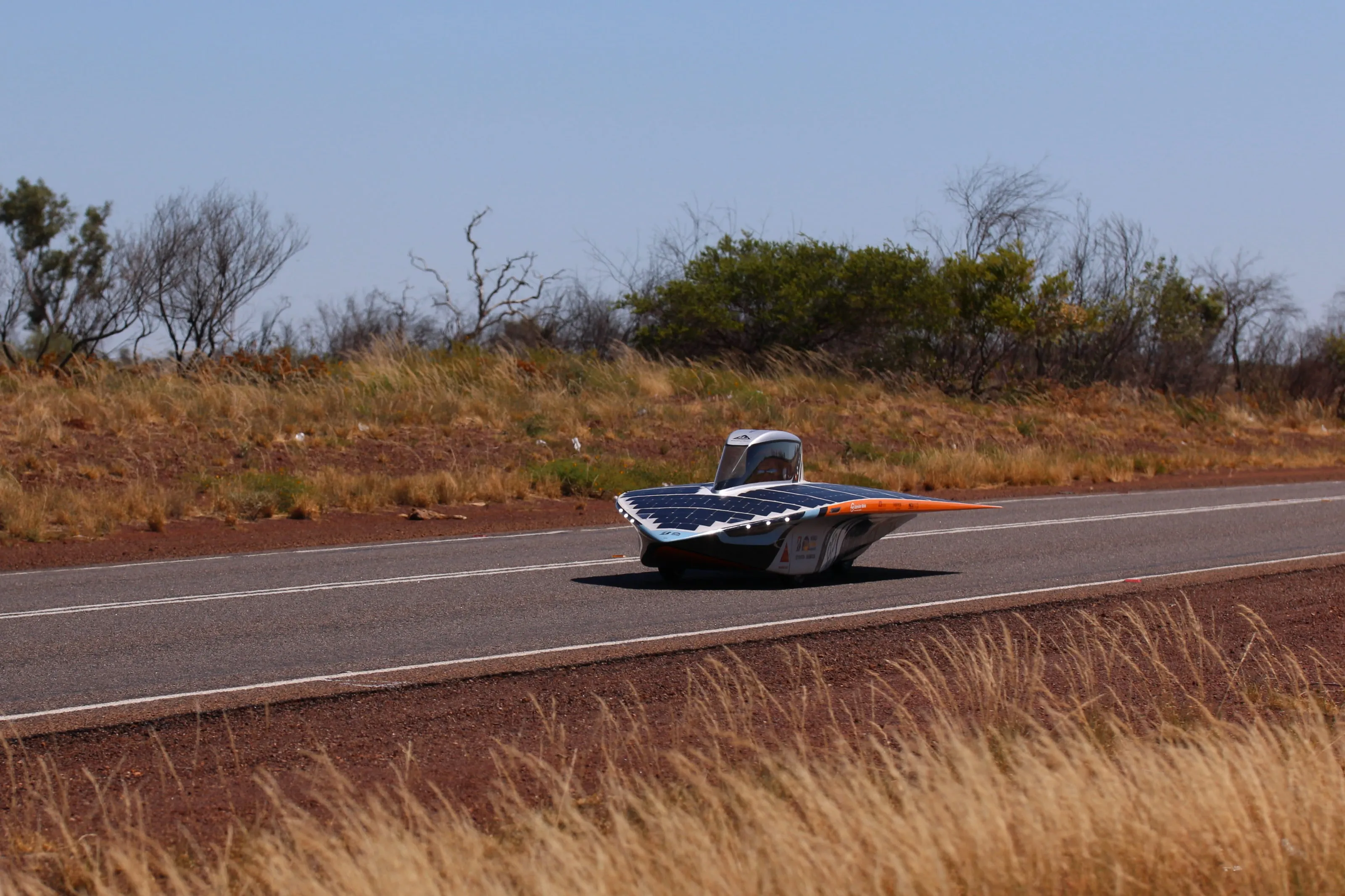 The solar car racing along an outback highway